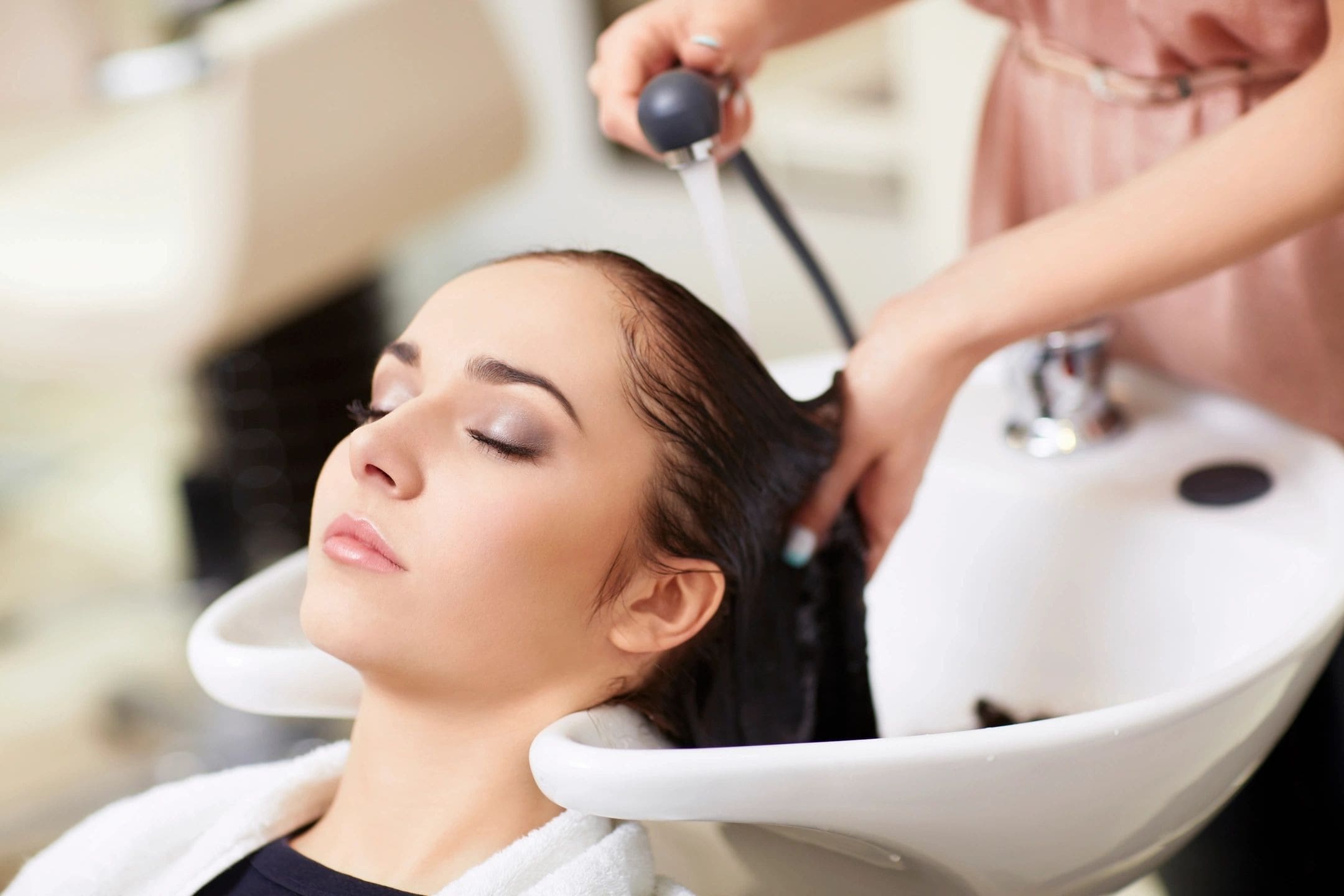 A woman getting her hair cut at the salon