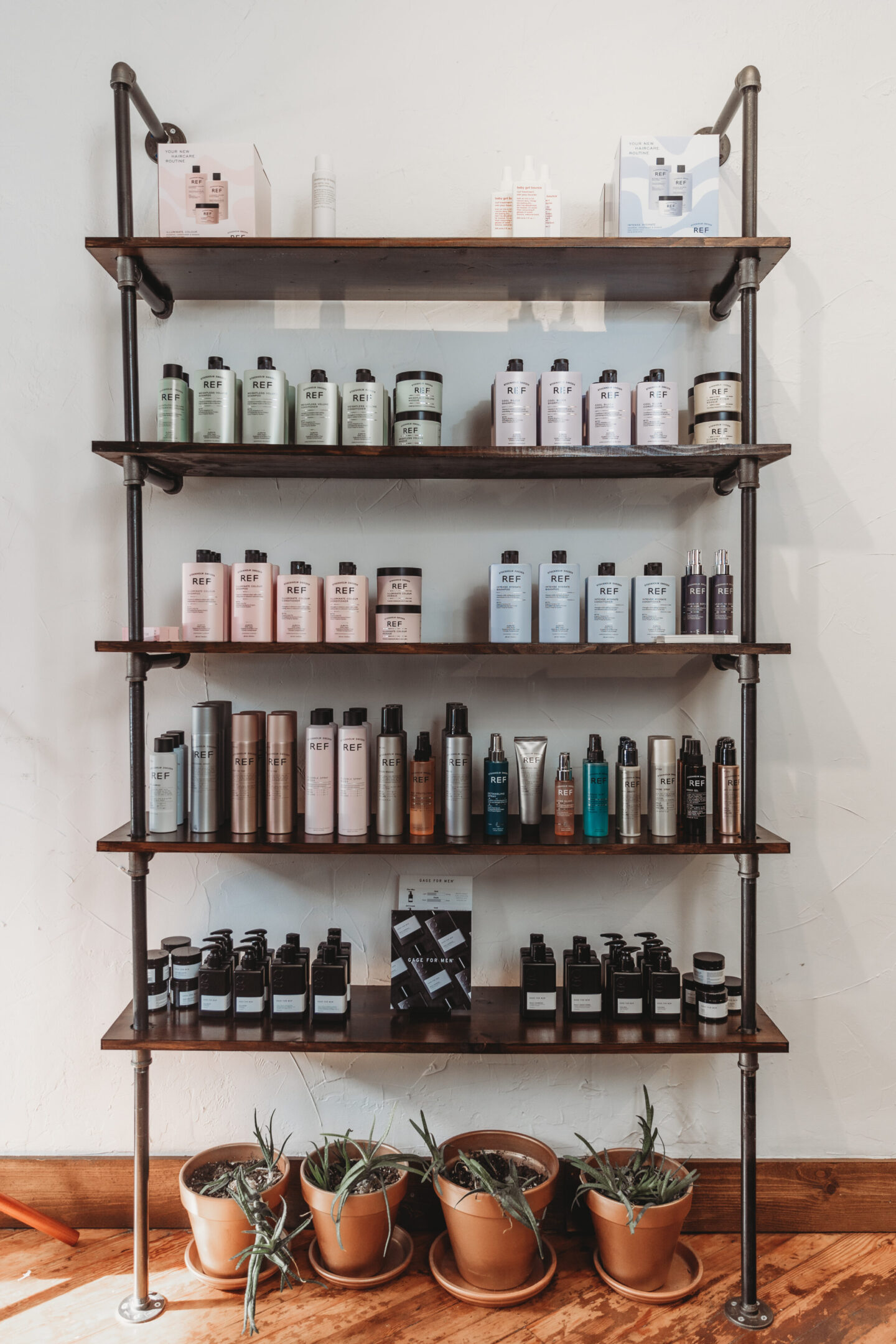 A shelf with many different hair products on it