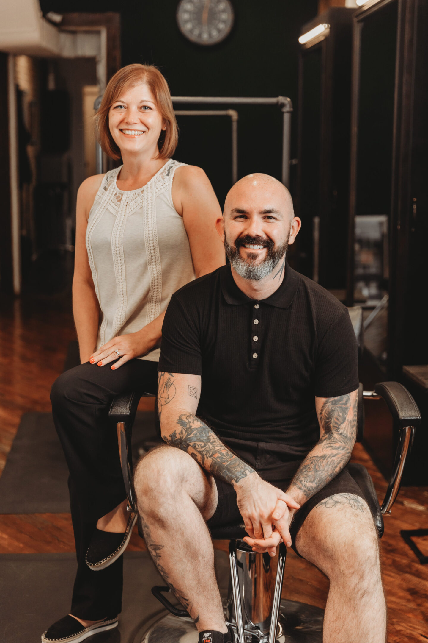 A man and woman sitting in a chair.